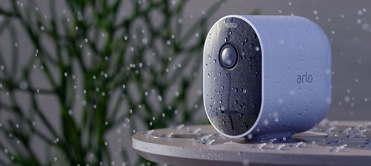 Arlo Pro 4 Wire-Free Camera is in the rain with water drops all over its body